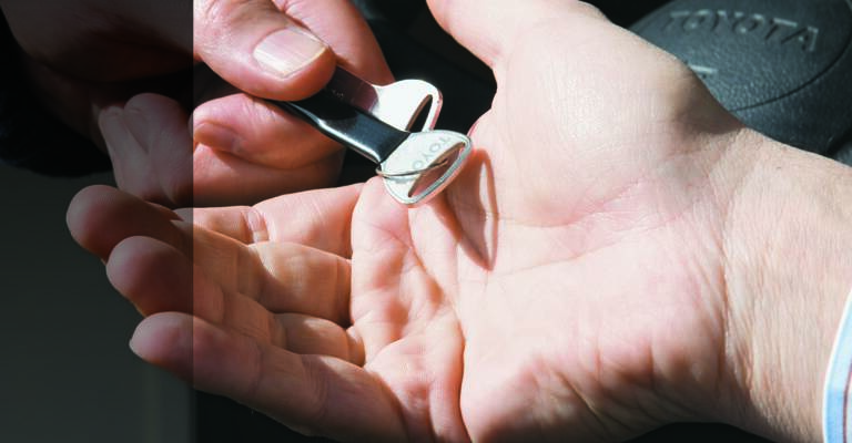 Keys being handed over between two hands
