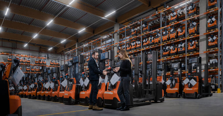Customer and sales man in front of Toyota rental fleet